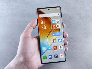 Hand holding a smartphone showing apps