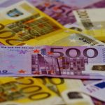 Euro banknotes stacked together