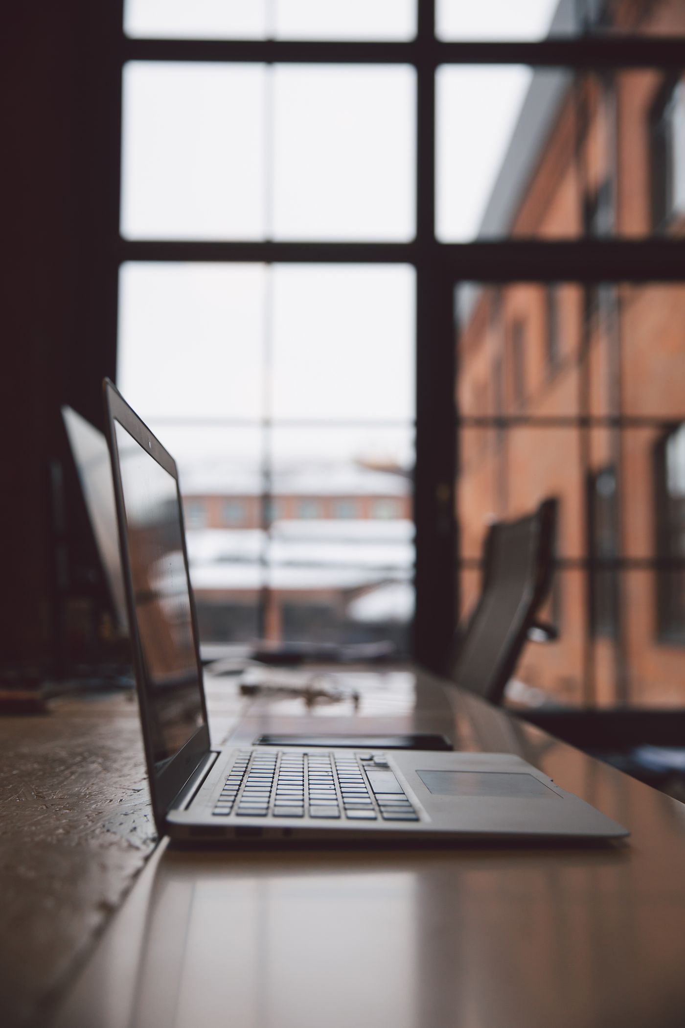 Modern office workspace with a laptop and rising charts